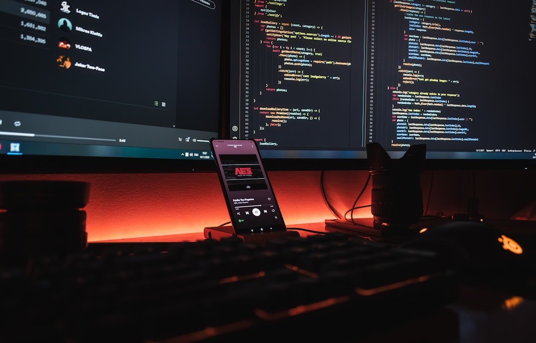 Mobile app developer coding on smartphone and laptop for a startup project