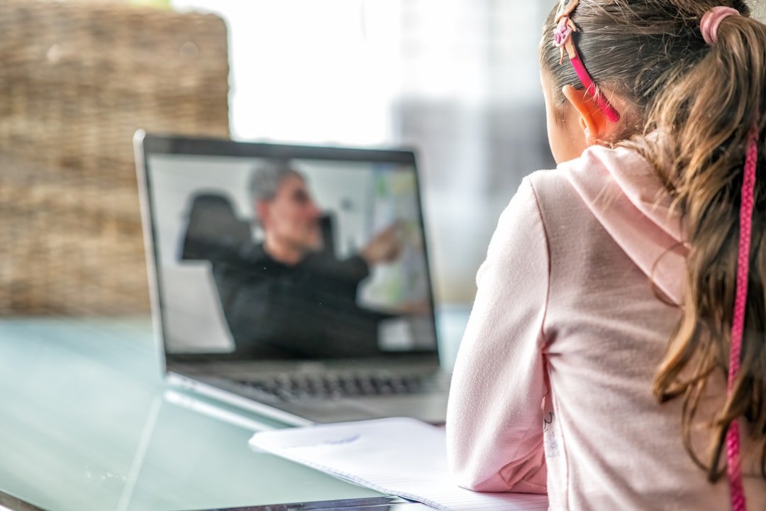 Online learning student following training lesson on laptop