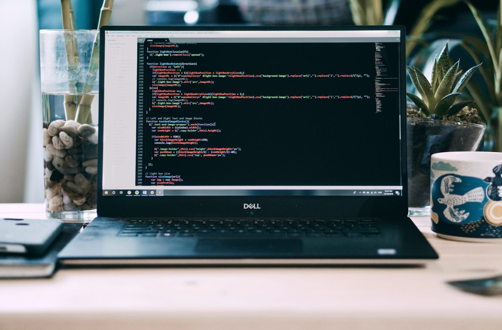 Modern web design workspace with laptop showing website layout