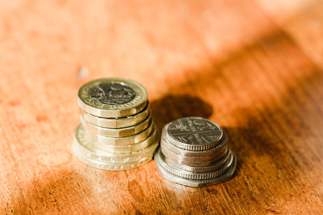 UK sterling pound coins representing website design cost budgeting